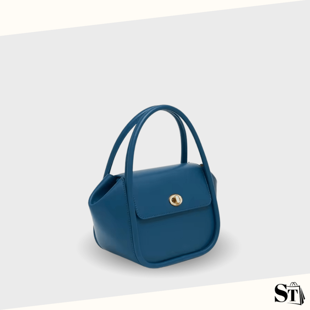 Sac à main tendance en cuir bleu pris en photo de 3/4 sur fond blanc