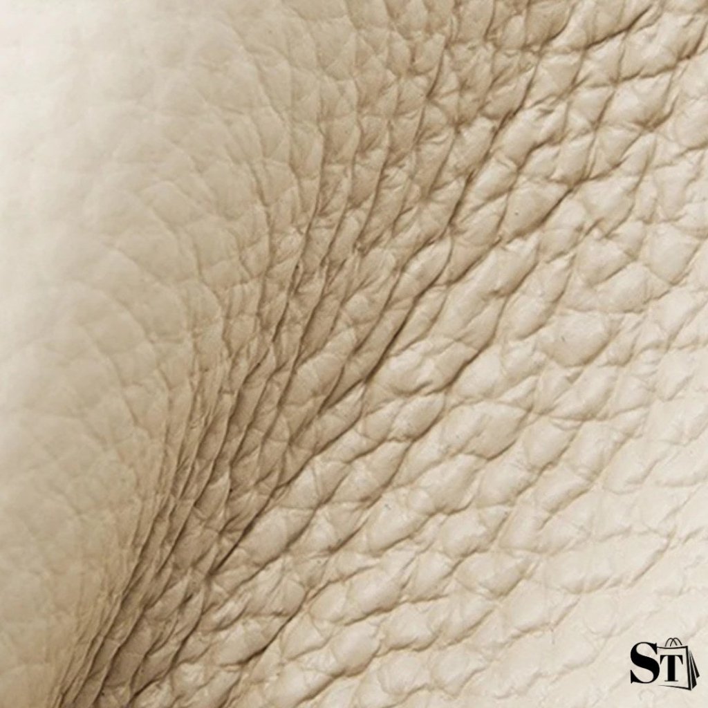 Gros plan sur le cuir véritable grainé du sac cabas Le Solène couleur ivoire.